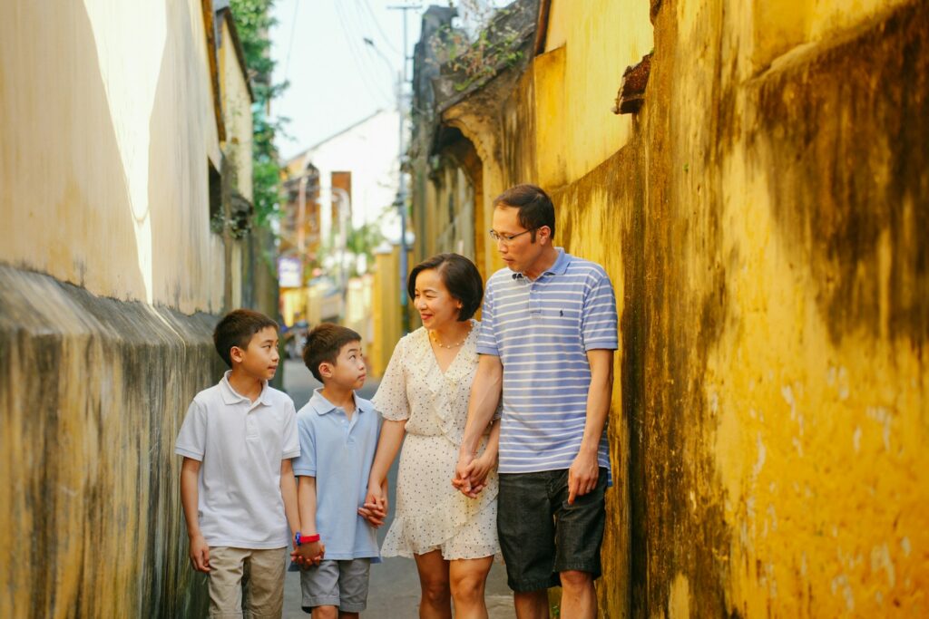 a family walking down a narrow alley way