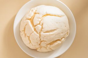 a white bowl filled with food on top of a table