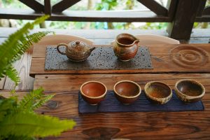 A wooden table topped with three cups of coffee